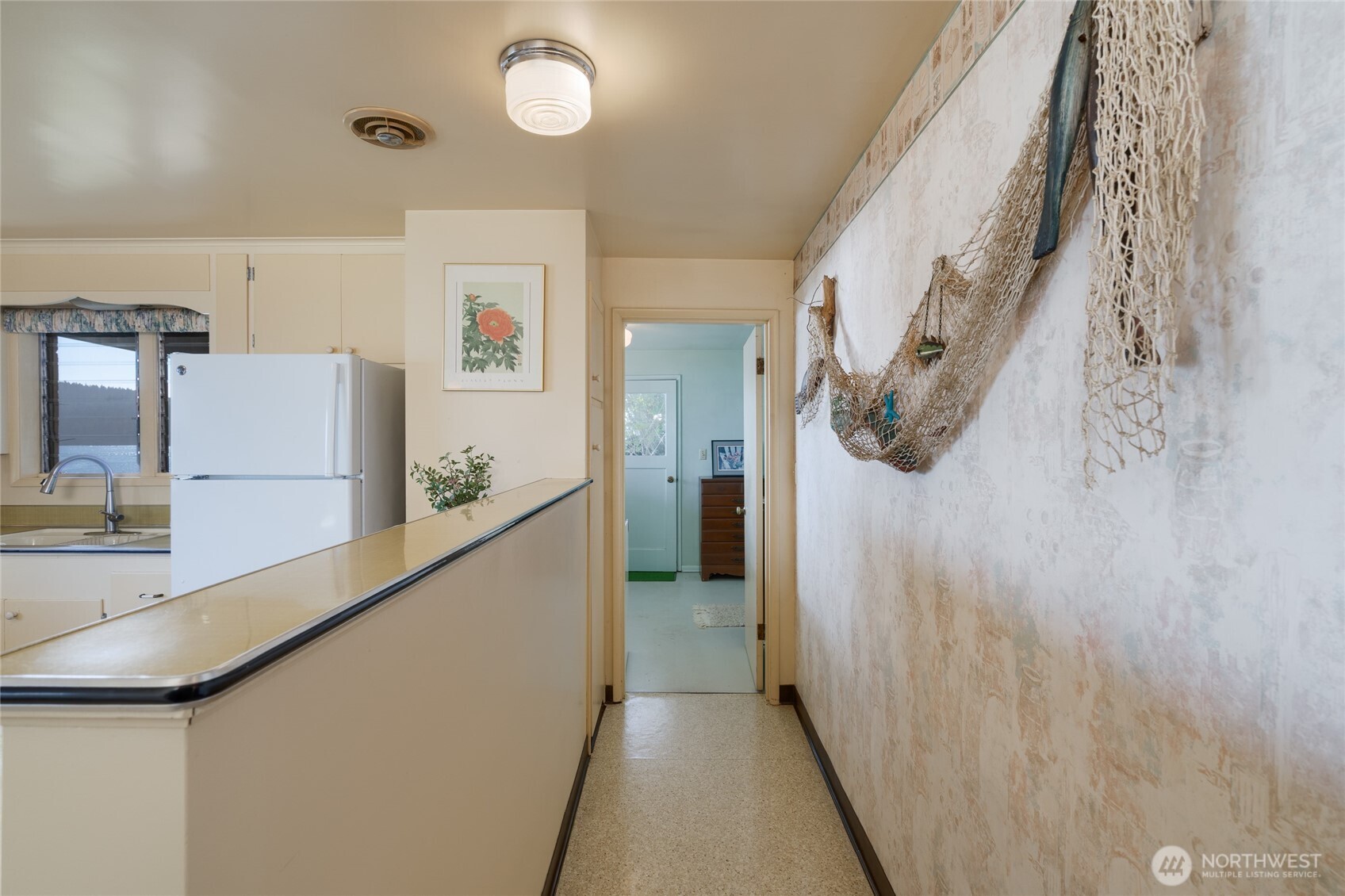 6860 Salmon Beach Road Anacortes, WA 98221 - Photo 31 of 40 a view of a hallway with wooden cabinets
