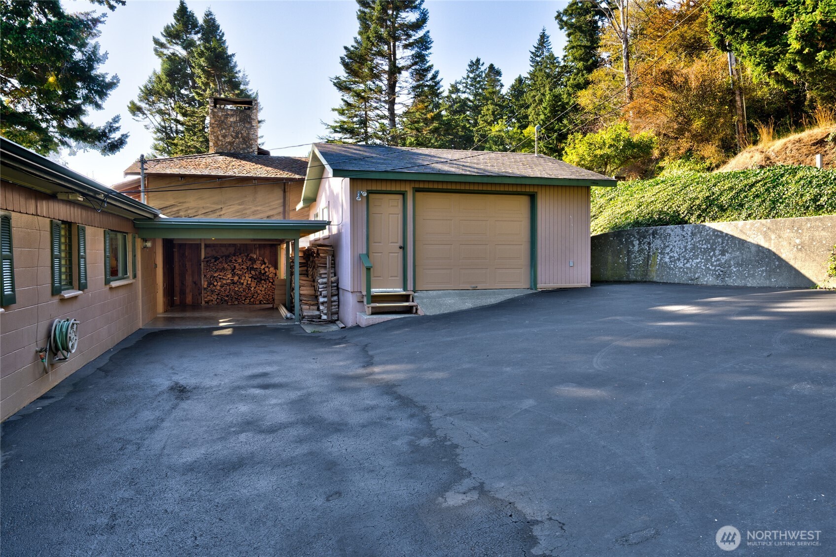6860 Salmon Beach Road Anacortes, WA 98221 - Photo 7 of 39 a view of a house with a garage and balcony