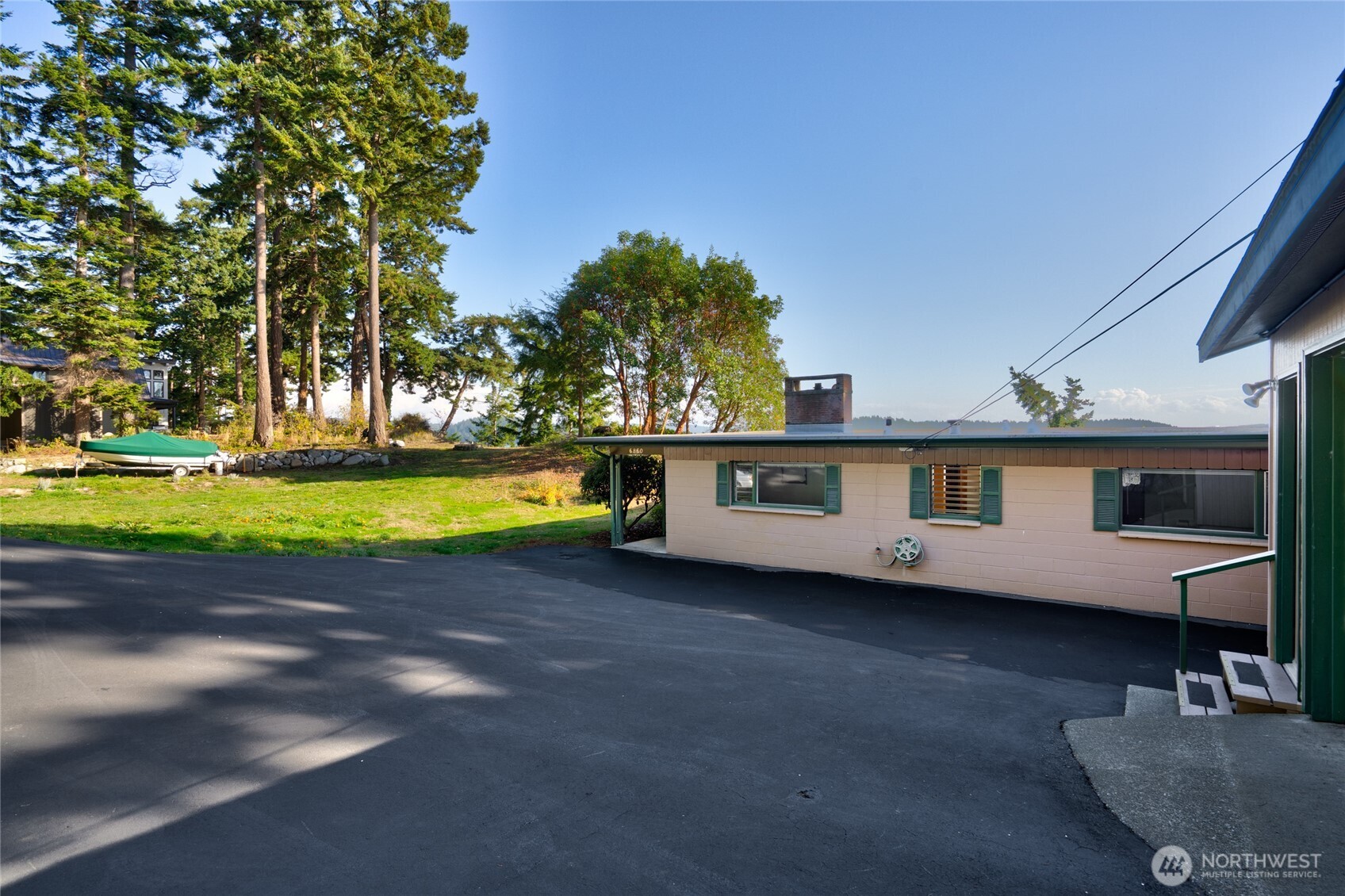 6860 Salmon Beach Road Anacortes, WA 98221 - Photo 9 of 40 a view of a house with backyard and a tree