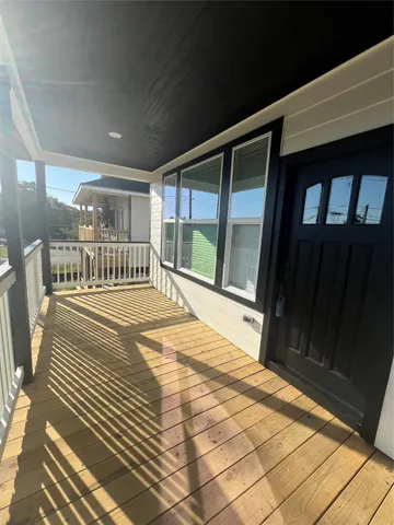a view of a porch with wooden floor
