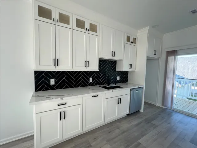 a kitchen with white cabinets