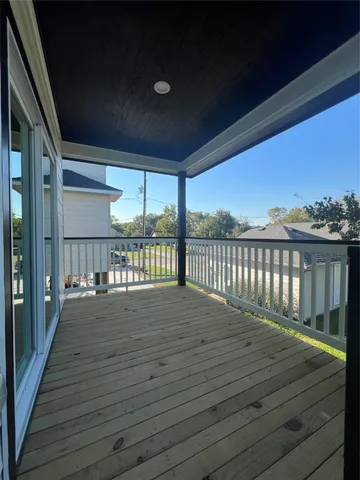 a view of a deck with wooden floor and roof with floor to ceiling window