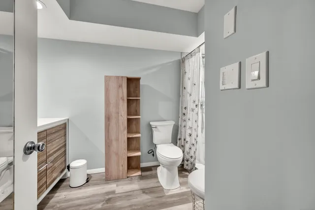 a bathroom with a toilet and a shower