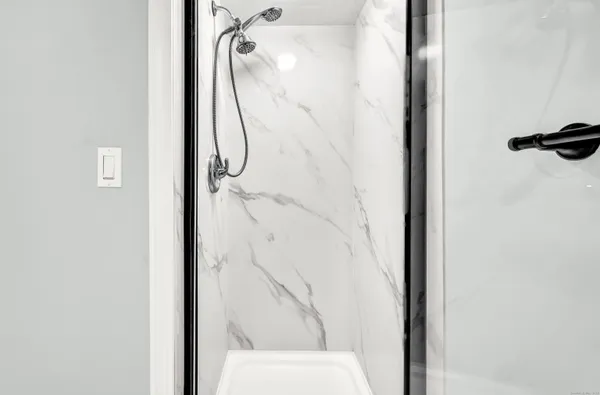 a bathroom with a toilet and a shower