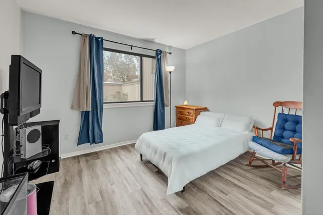 a bedroom with a bed and wooden floor