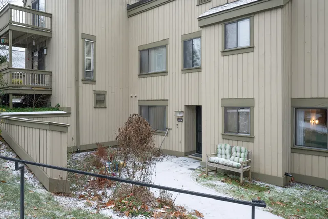 a front view of a house with chairs