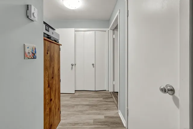 a view of a hallway with wooden floor