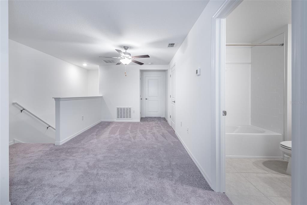 14348 Editors Note Street Ruskin, FL 33573 - Photo 13 of 24 a view of a bathroom with a bathtub and a shower
