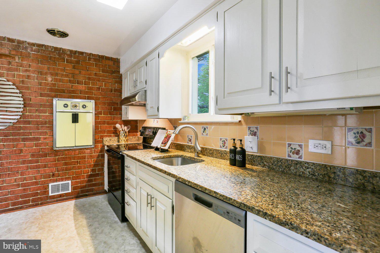 907 Hoyt Street Silver Spring, MD 20902 - Photo 20 of 69 a kitchen with stainless steel appliances granite countertop a sink stove and cabinets