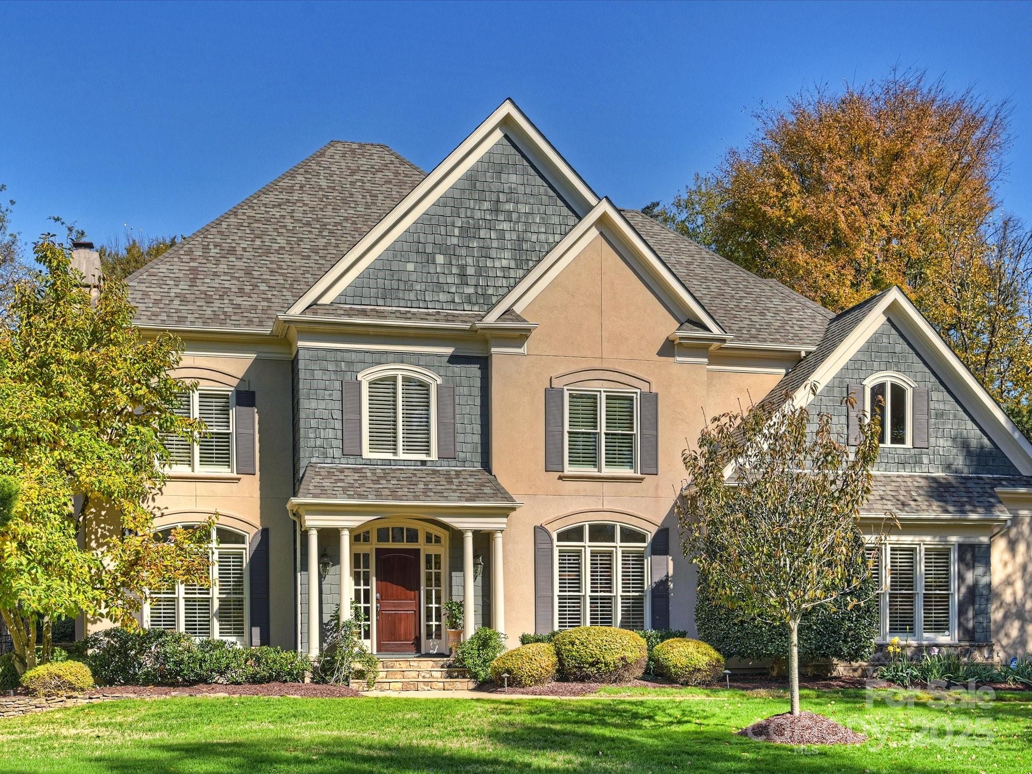 a front view of a house with a garden
