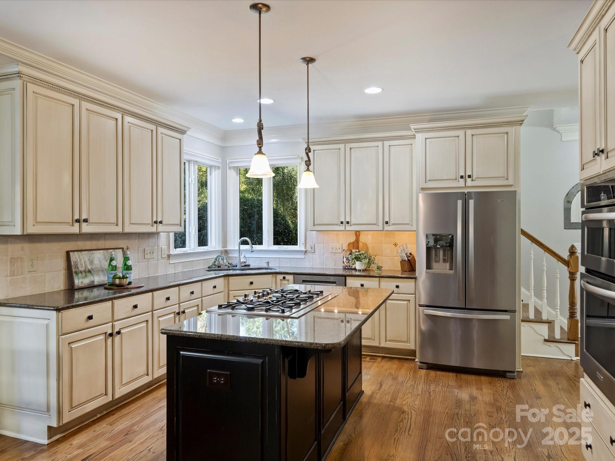 1738 Bardstown Road Charlotte, NC 28226 - Photo 17 of 40 a kitchen with kitchen island granite countertop a sink appliances and cabinets