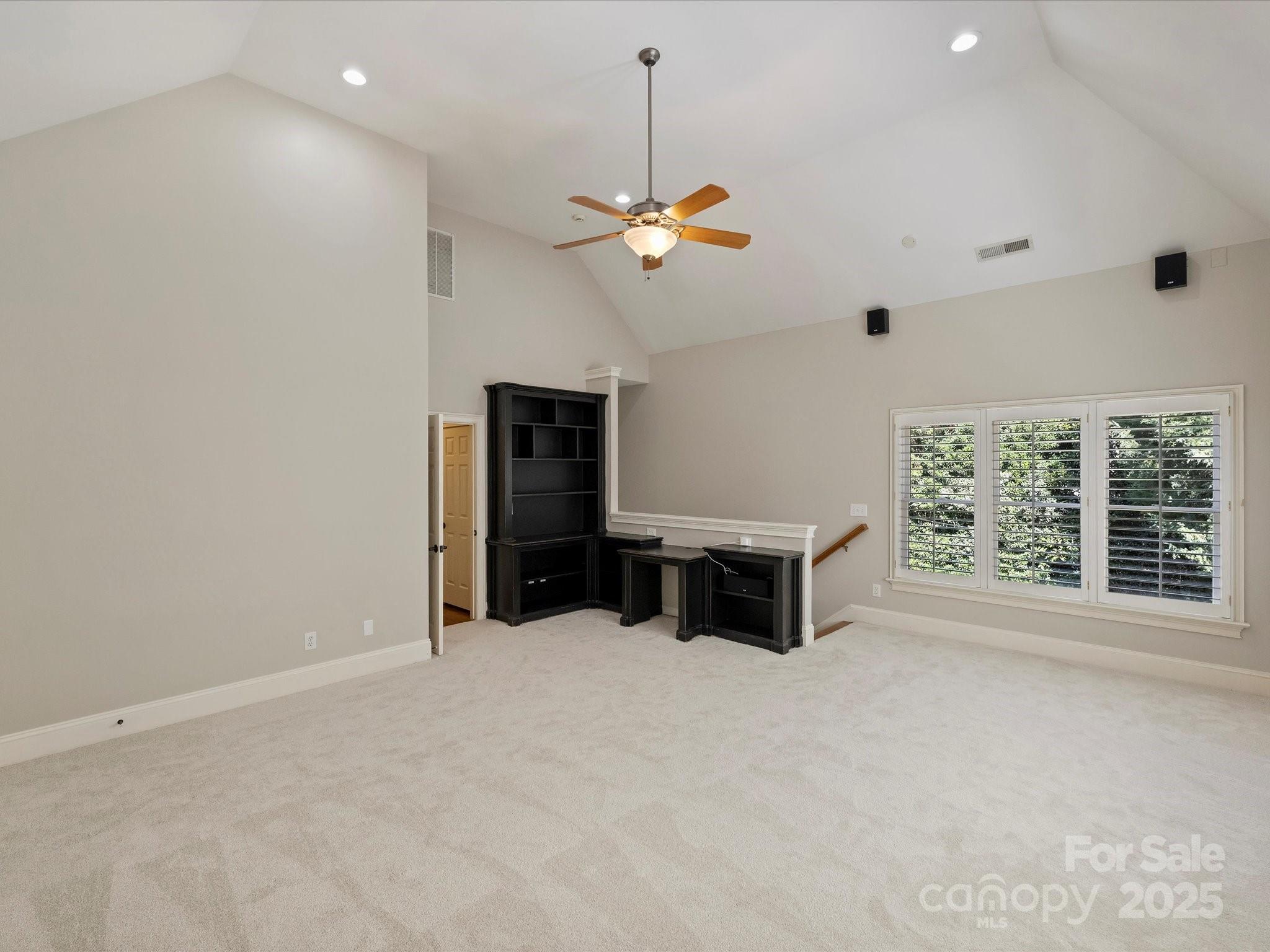 1738 Bardstown Road Charlotte, NC 28226 - Photo 33 of 40 en empty room with windows and ceiling fan