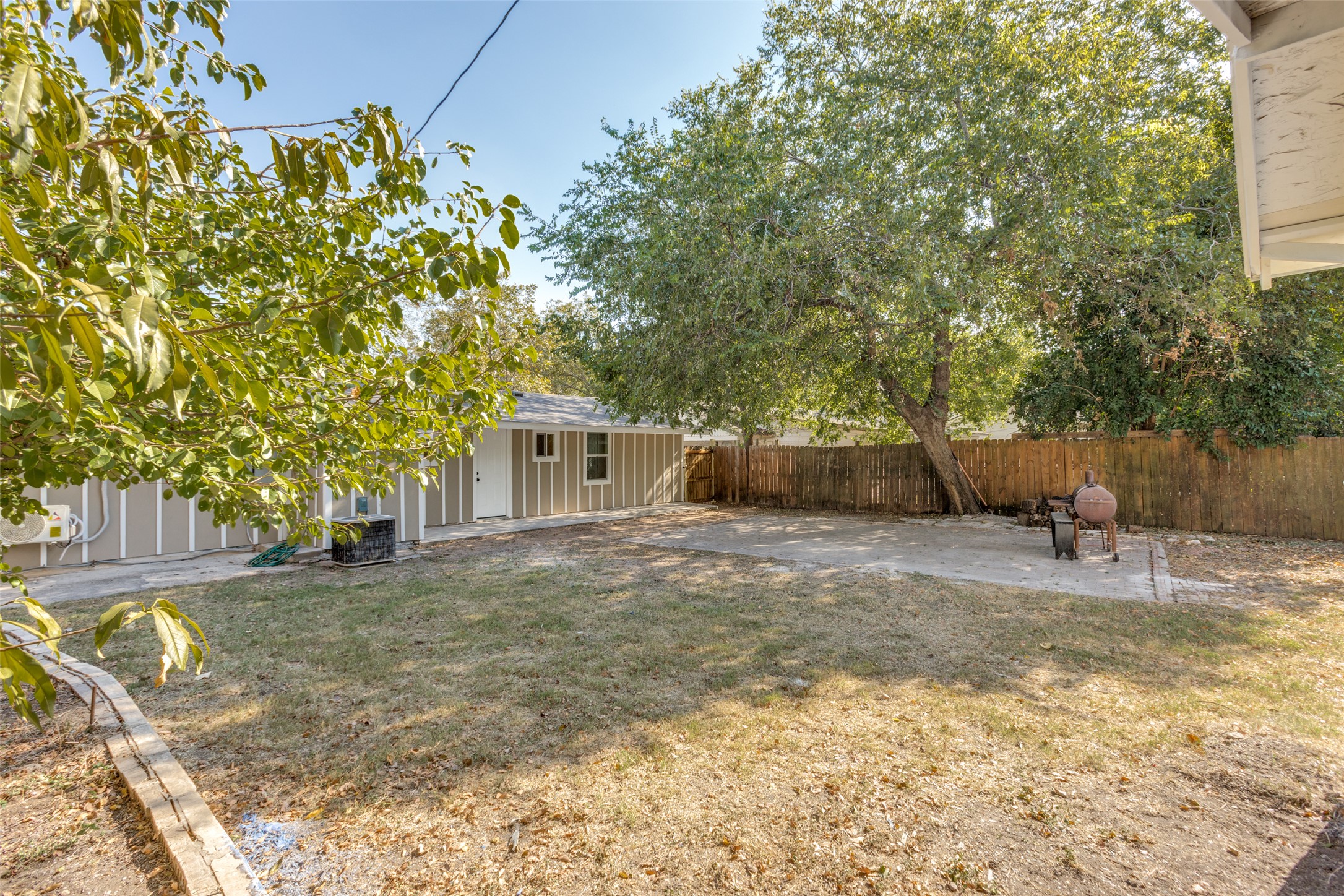 1118 Spur Street Austin, TX 78721 - Photo 18 of 21 A spacious private yard features mature trees and a sturdy wood fence.