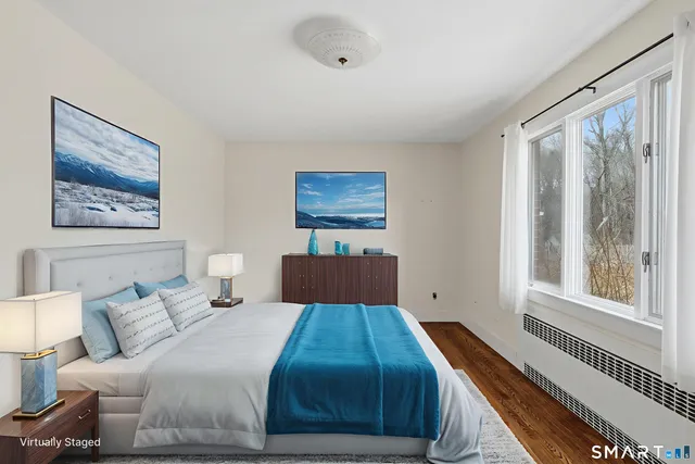 a bedroom with a bed and a large window