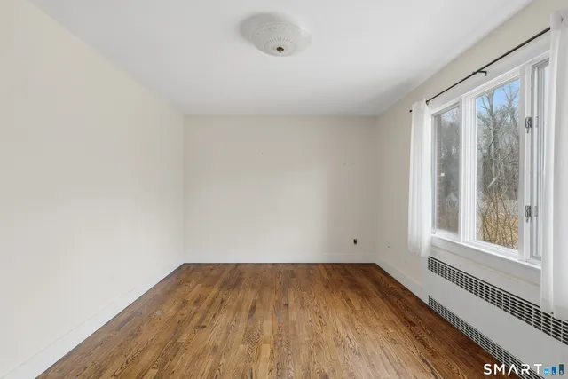 a view of a room with wooden floor and windows