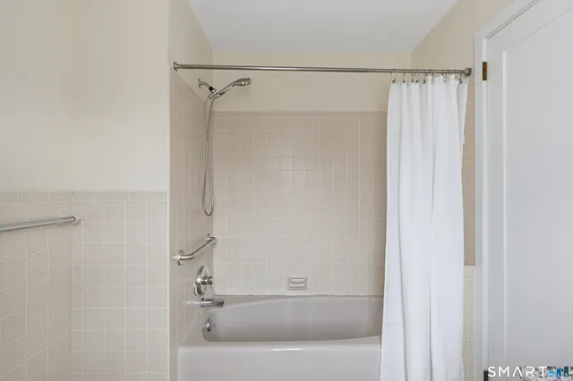 a bathroom with a bathtub and a shower