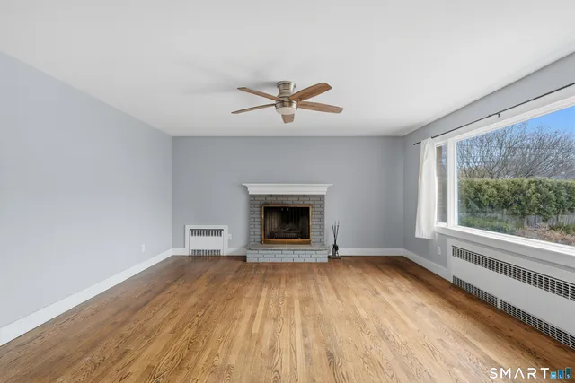 wooden floor in an empty room with a window