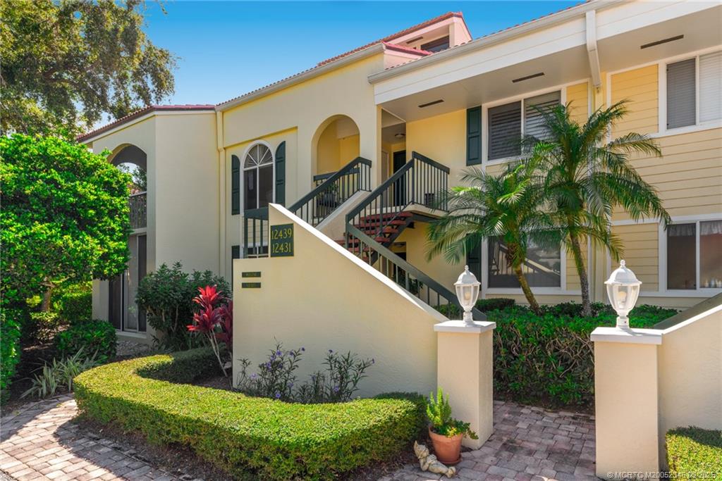 12431 Harbour Ridge Boulevard, Unit 31 Palm City, FL 34990 - Photo 1 of 12 a front view of a house with garden