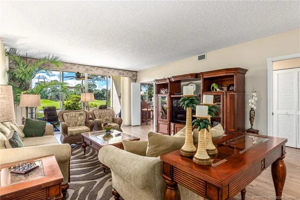 a living room with furniture and a floor to ceiling window