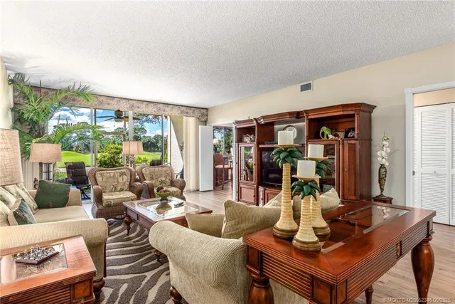 a living room with furniture and a floor to ceiling window