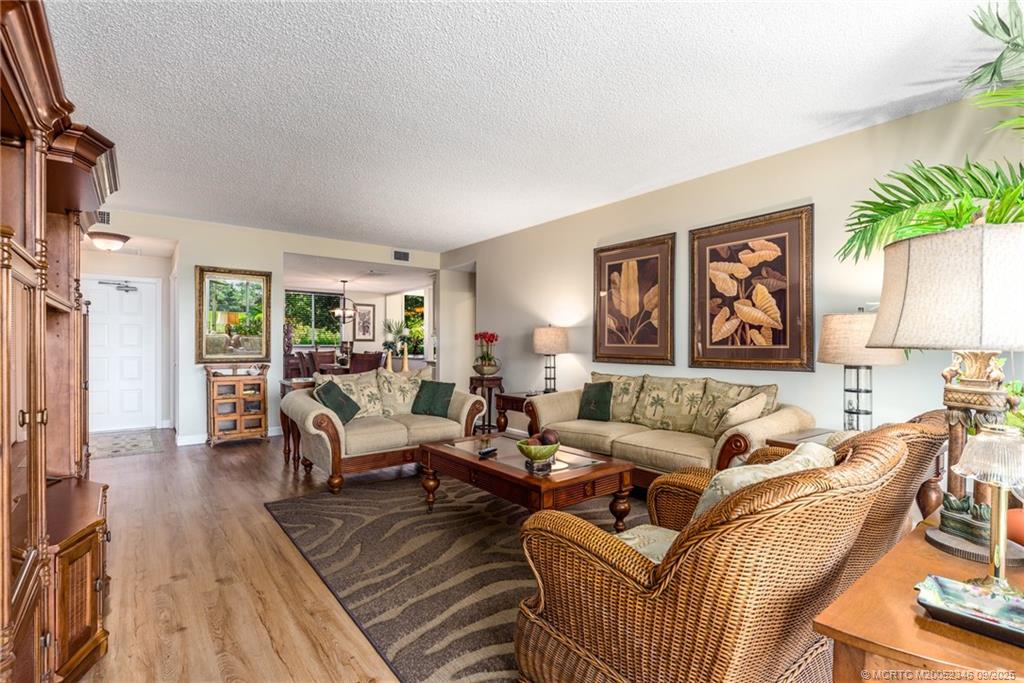 12431 Harbour Ridge Boulevard, Unit 31 Palm City, FL 34990 - Photo 3 of 12 a living room with furniture and a wooden floor