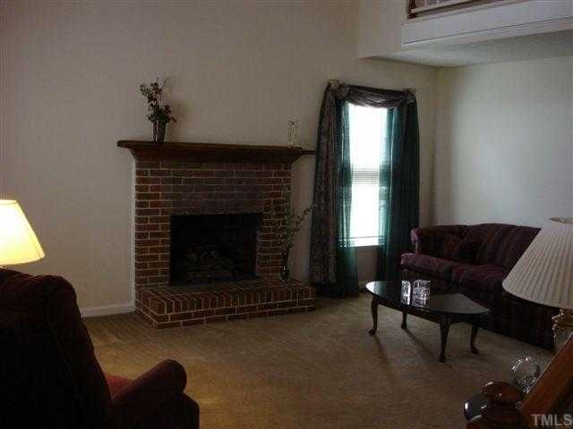 4420 Emmit Drive Raleigh, NC 27604 - Photo 4 of 6 a living room with furniture and a fireplace