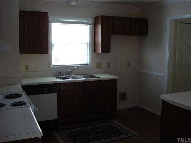 4420 Emmit Drive Raleigh, NC 27604 - Photo 5 of 6 a kitchen with a sink a stove and a microwave