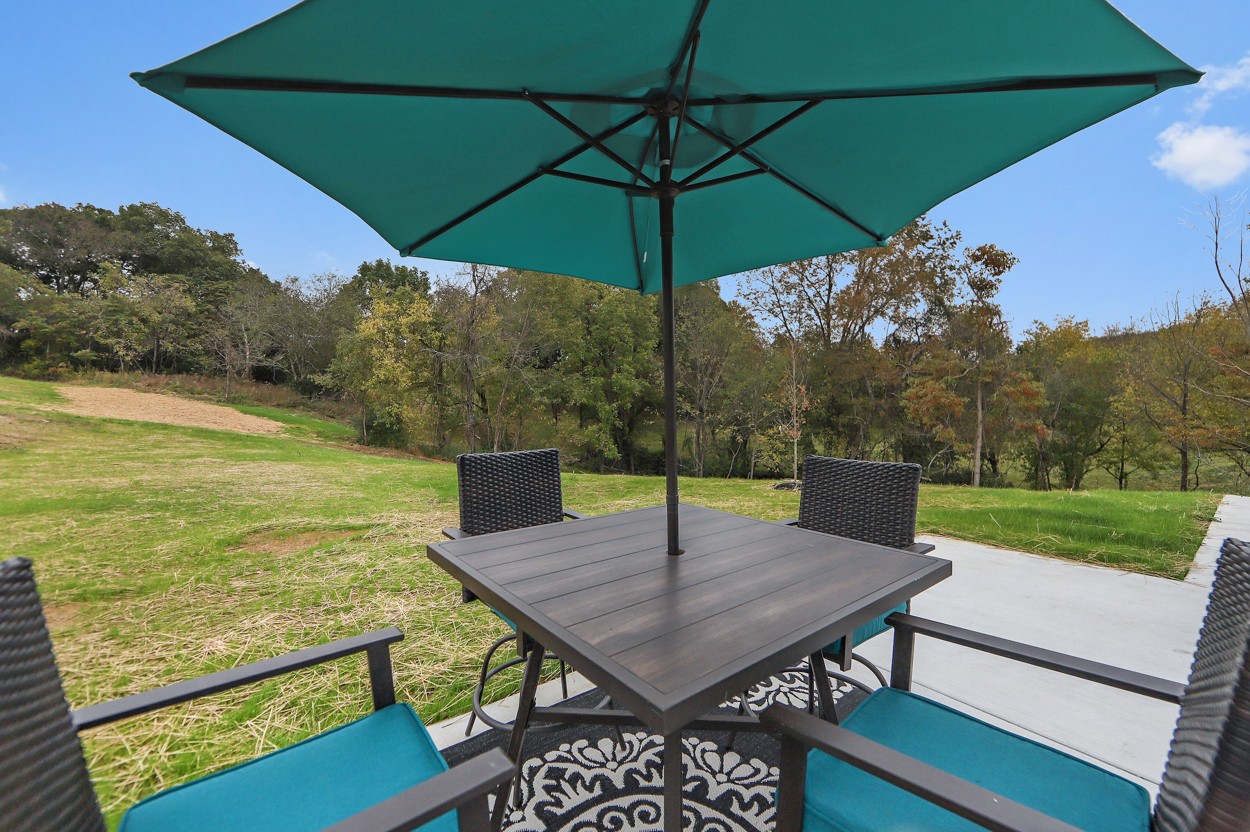 25 Riadon Road Hartsville, TN 37074 - Photo 2 of 19 a view of a roof deck with table and chairs under an umbrella