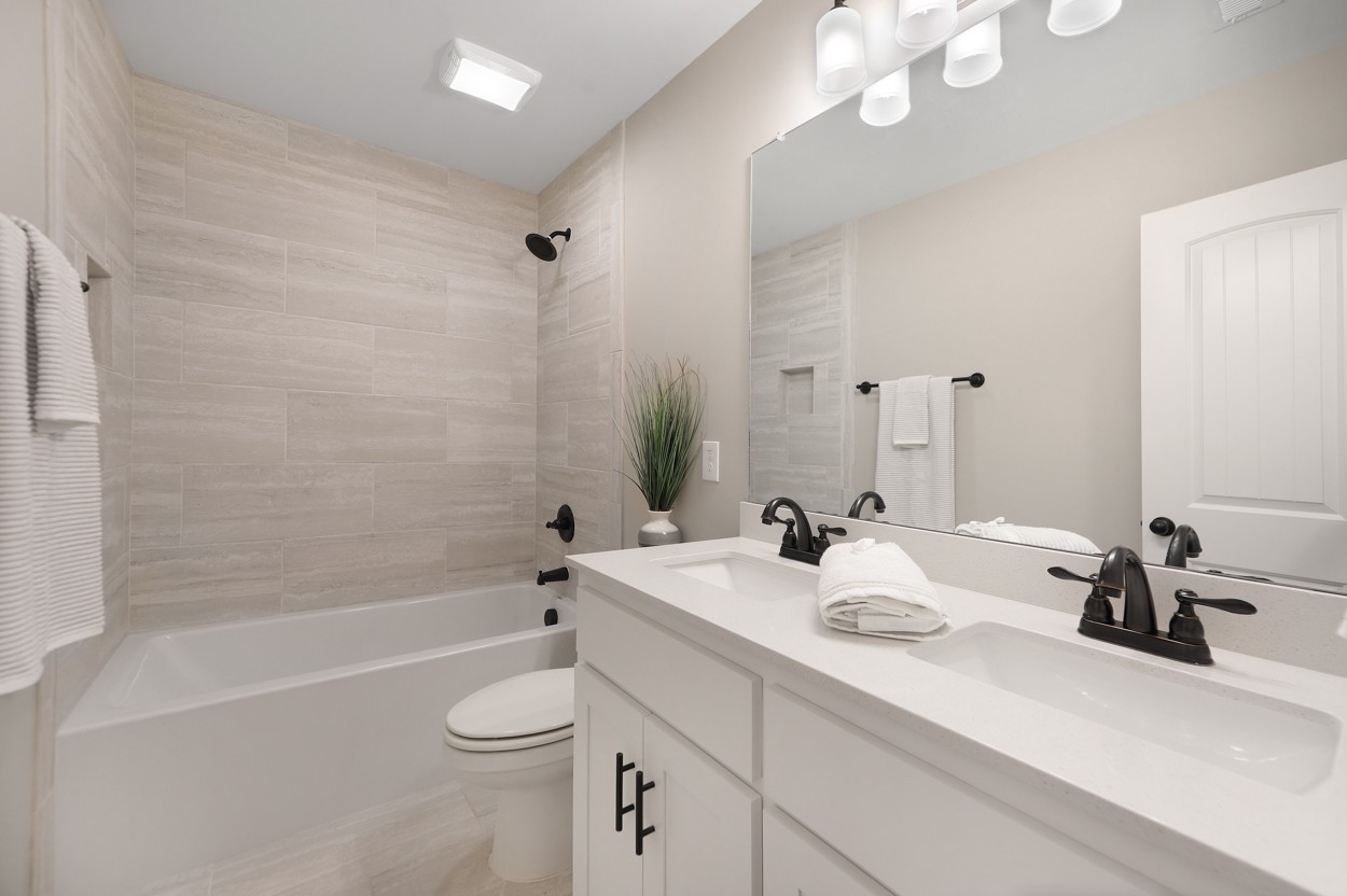 25 Riadon Road Hartsville, TN 37074 - Photo 17 of 19 a bathroom with a double vanity sink toilet and shower