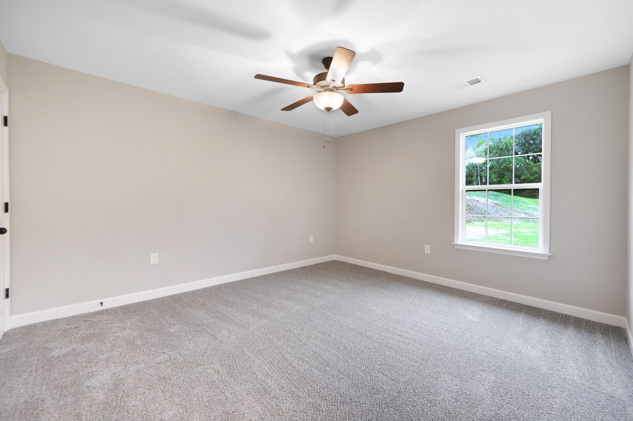 25 Riadon Road Hartsville, TN 37074 - Photo 18 of 19 an empty room with windows and fan