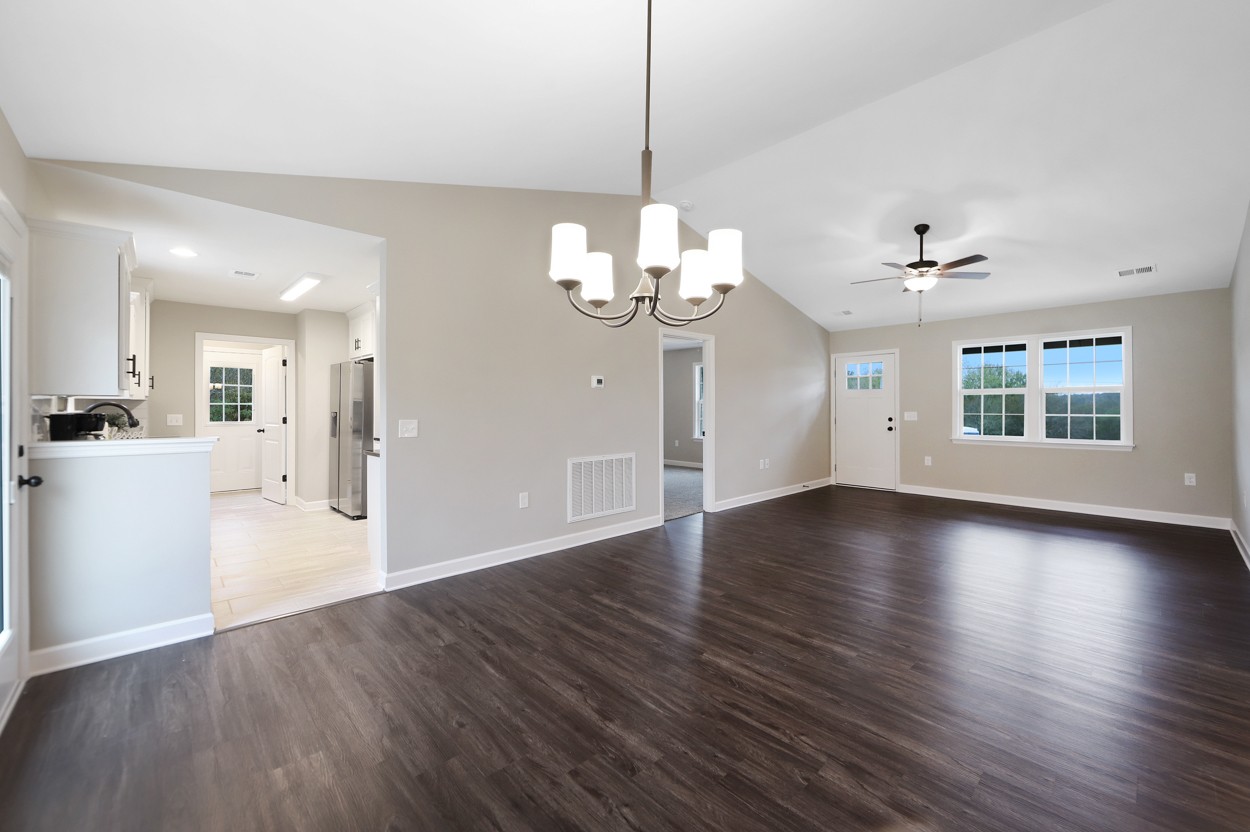 25 Riadon Road Hartsville, TN 37074 - Photo 4 of 19 a view of an empty room with wooden floor and a kitchen
