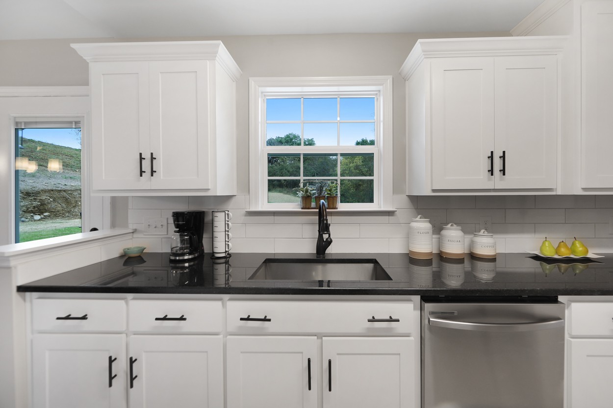 25 Riadon Road Hartsville, TN 37074 - Photo 6 of 19 a kitchen with white cabinets and a window
