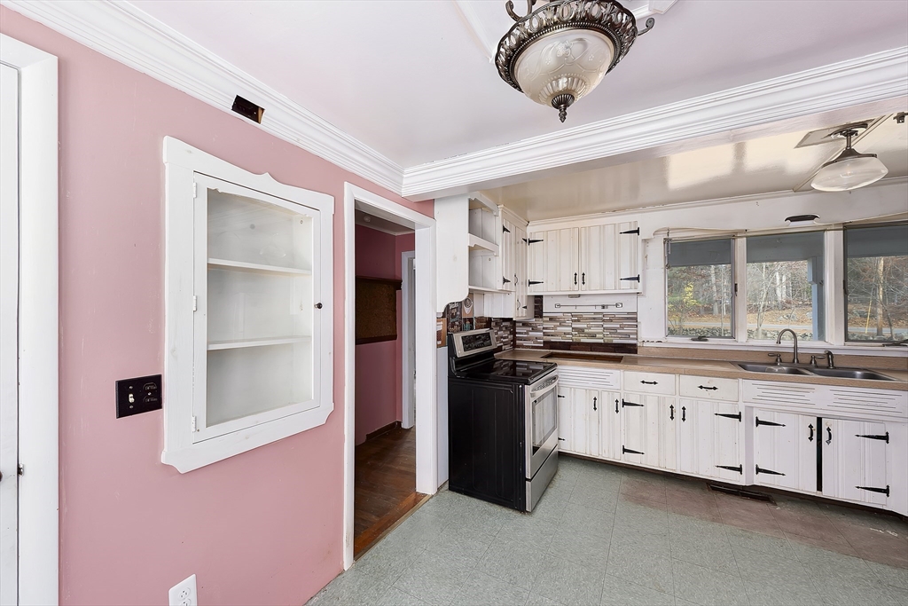 16 Killam Hill Road Boxford, MA 01921 - Photo 5 of 34 a kitchen with granite countertop a sink stainless steel appliances and cabinets