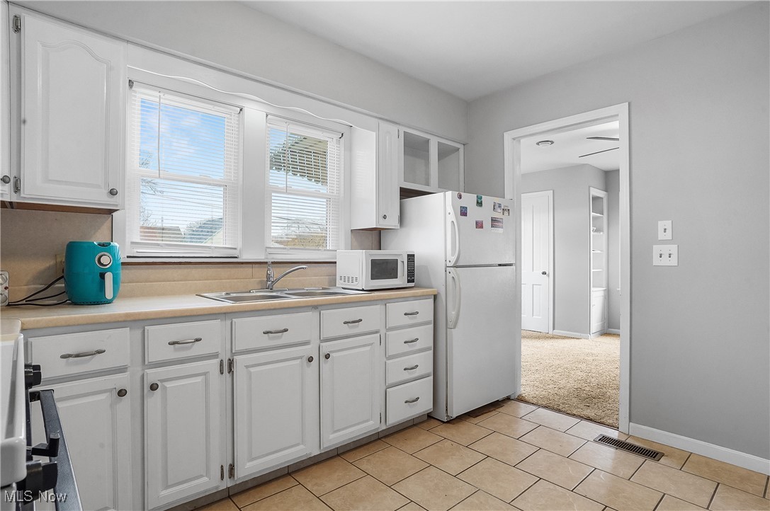 3206 9th Street Northwest Canton, OH 44708 - Photo 28 of 32 Kitchen with sink, white cabinets, and white appliances