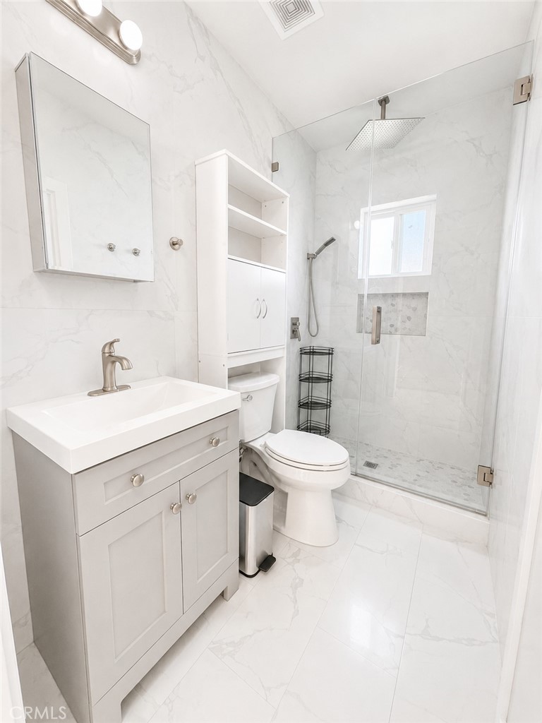 18924 Vose Street Reseda, CA 91335 - Photo 8 of 8 a bathroom with a sink toilet and shower