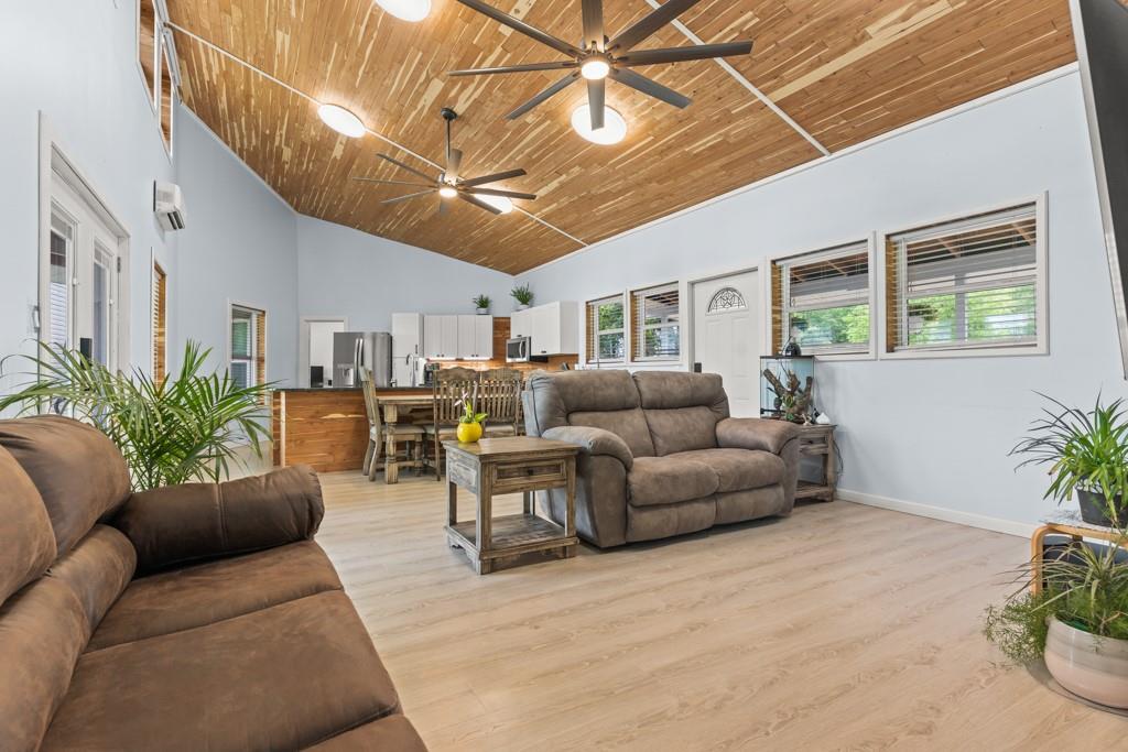 1129 Holly Road Gilmer, TX 75644 - Photo 12 of 31 Vaulted wood-finish ceiling featuring exposed beams and multiple ceiling fans