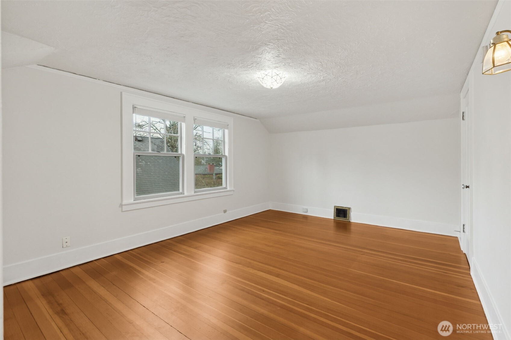 2305 Columbia Street Southwest Olympia, WA 98501 - Photo 19 of 34 a view of an empty room with wooden floor and a window