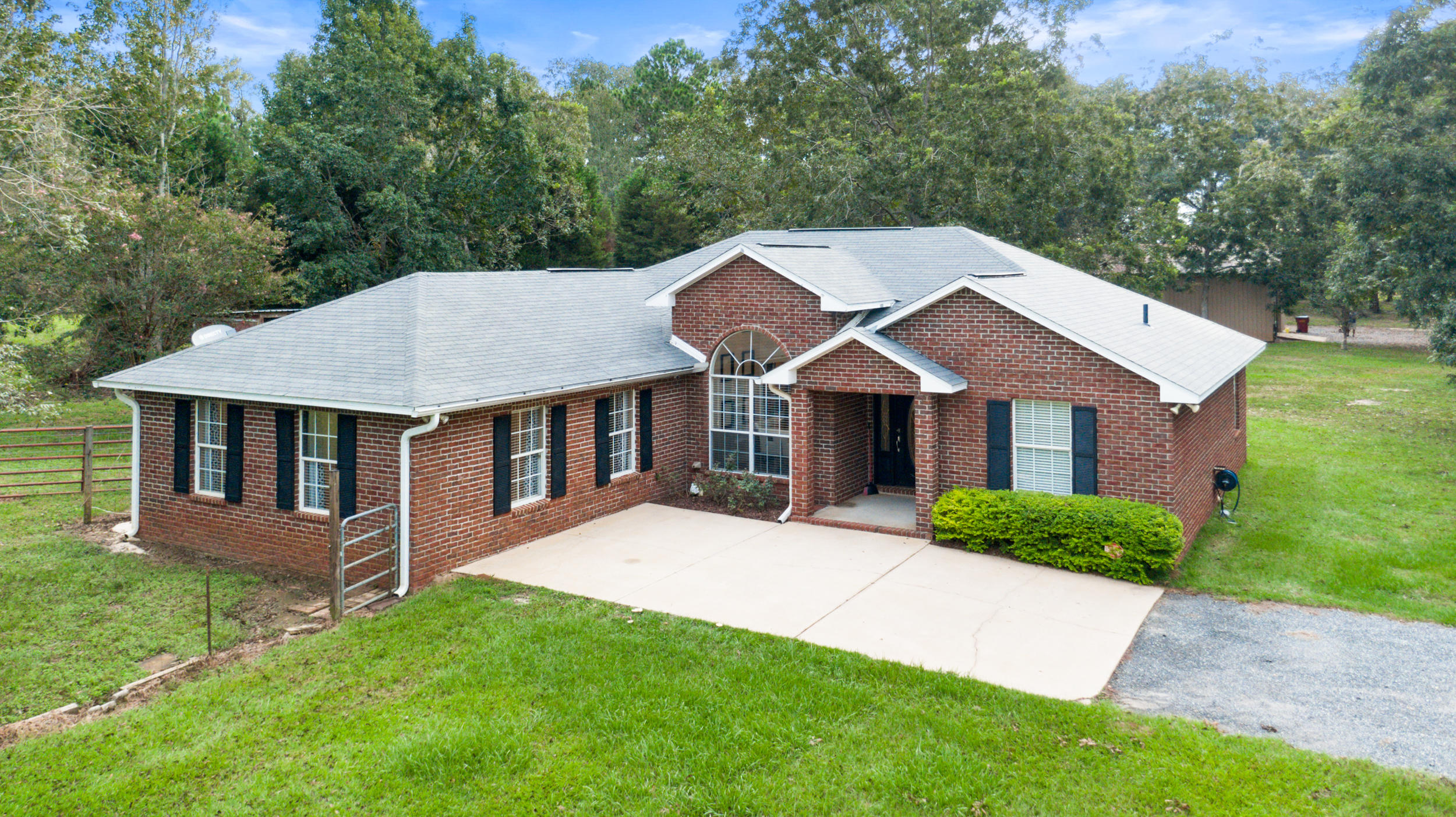 5975 Jack Stokes Road Baker, FL 32531 - Photo 1 of 44 a front view of a house with yard and trees