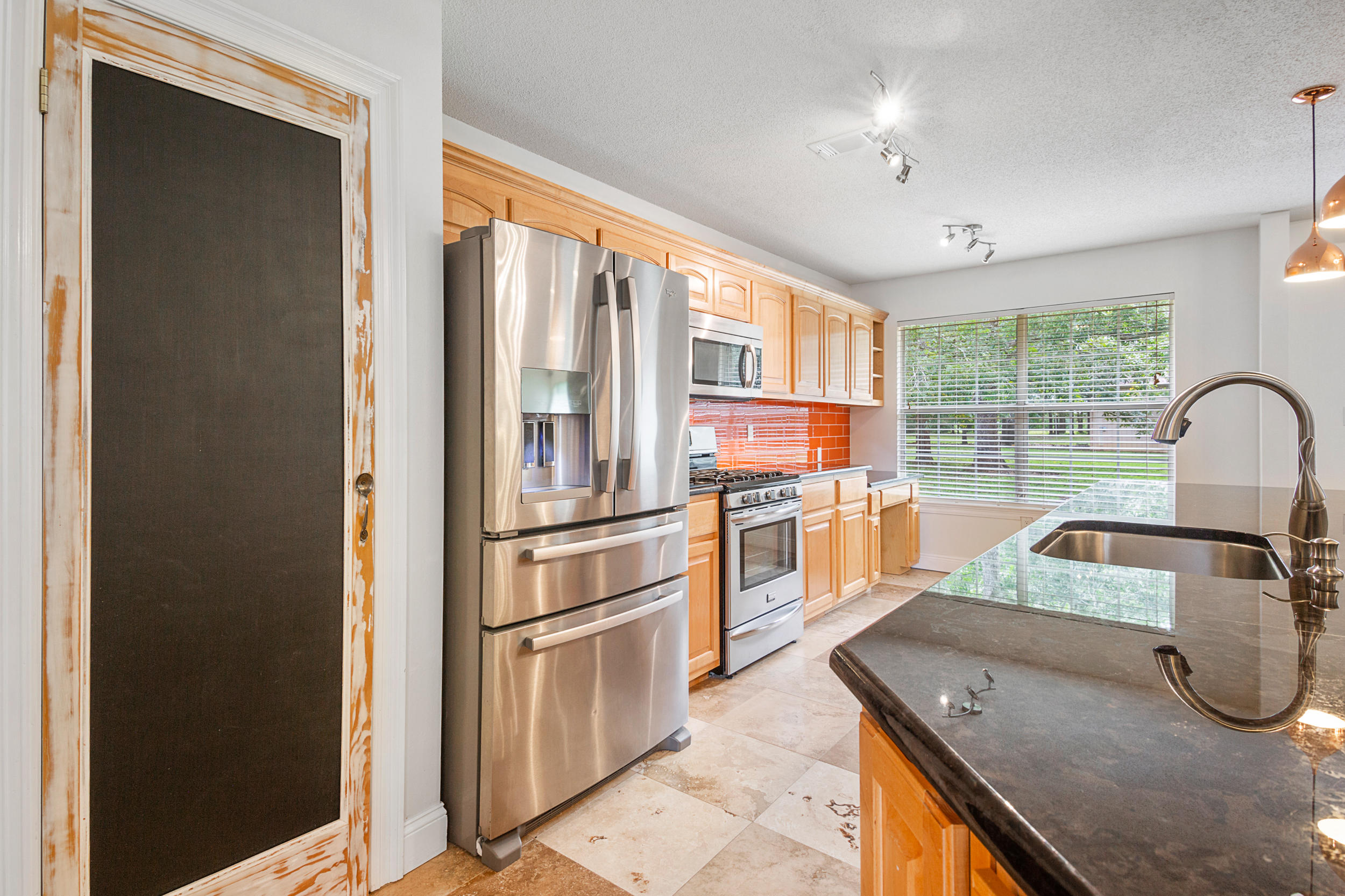 5975 Jack Stokes Road Baker, FL 32531 - Photo 11 of 44 a kitchen with a refrigerator and a sink