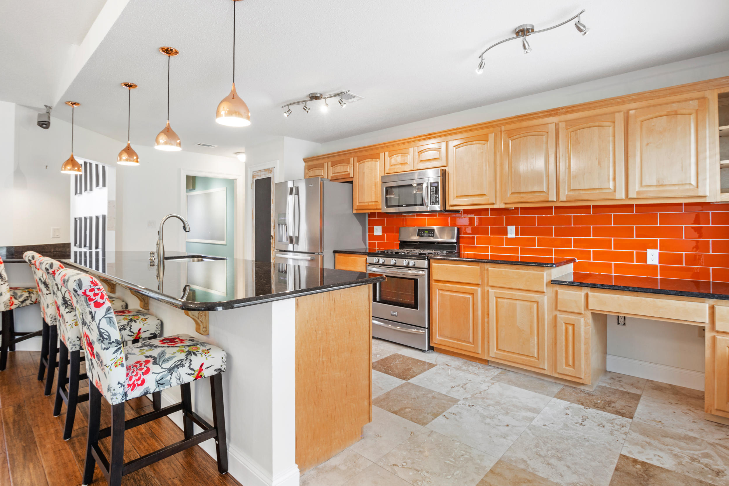5975 Jack Stokes Road Baker, FL 32531 - Photo 13 of 44 a kitchen with stainless steel appliances kitchen island granite countertop a stove a sink and cabinets