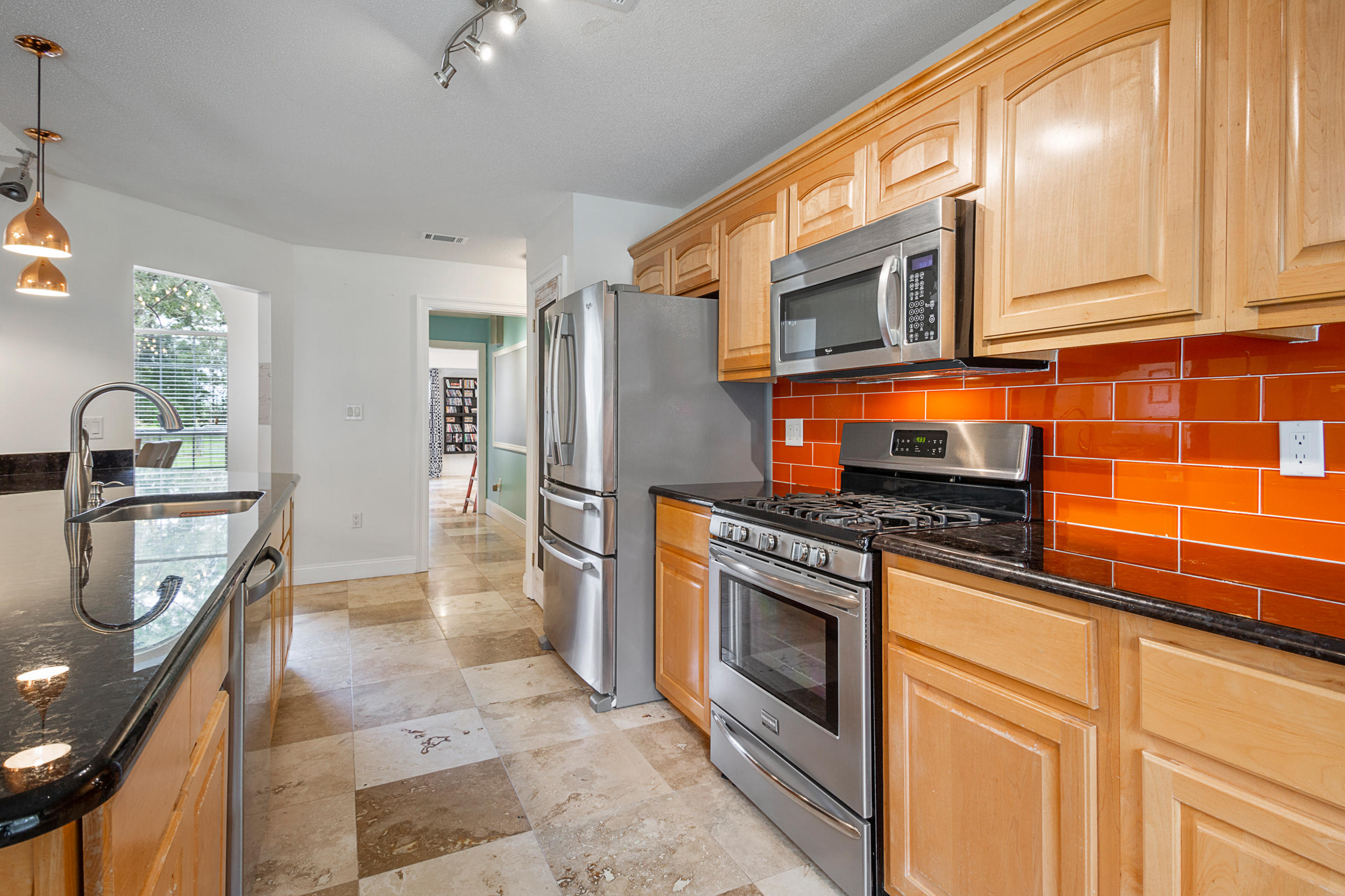 5975 Jack Stokes Road Baker, FL 32531 - Photo 14 of 44 a kitchen with stainless steel appliances granite countertop a stove a sink and a microwave