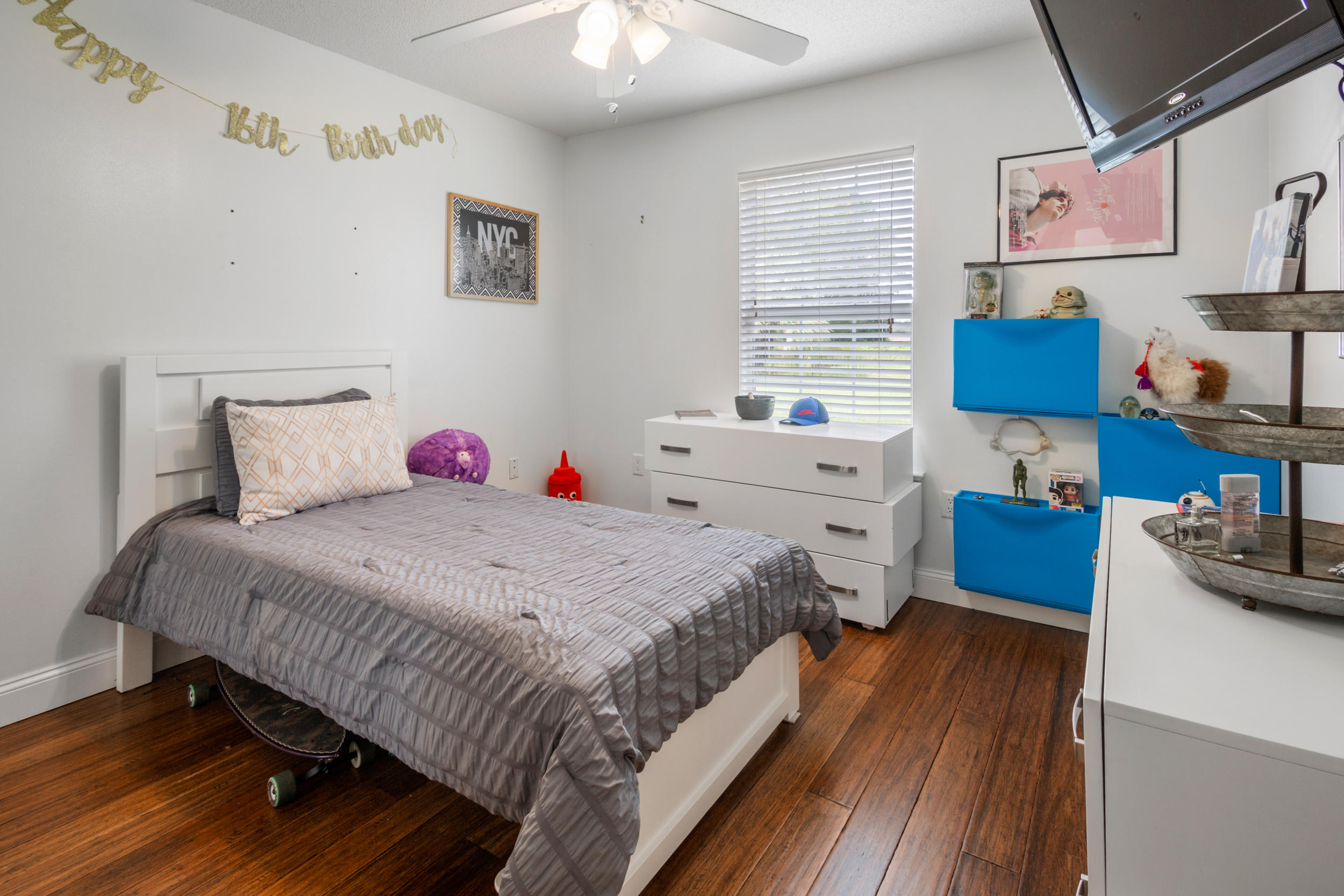 5975 Jack Stokes Road Baker, FL 32531 - Photo 18 of 44 a bedroom with a bed and a wooden floor