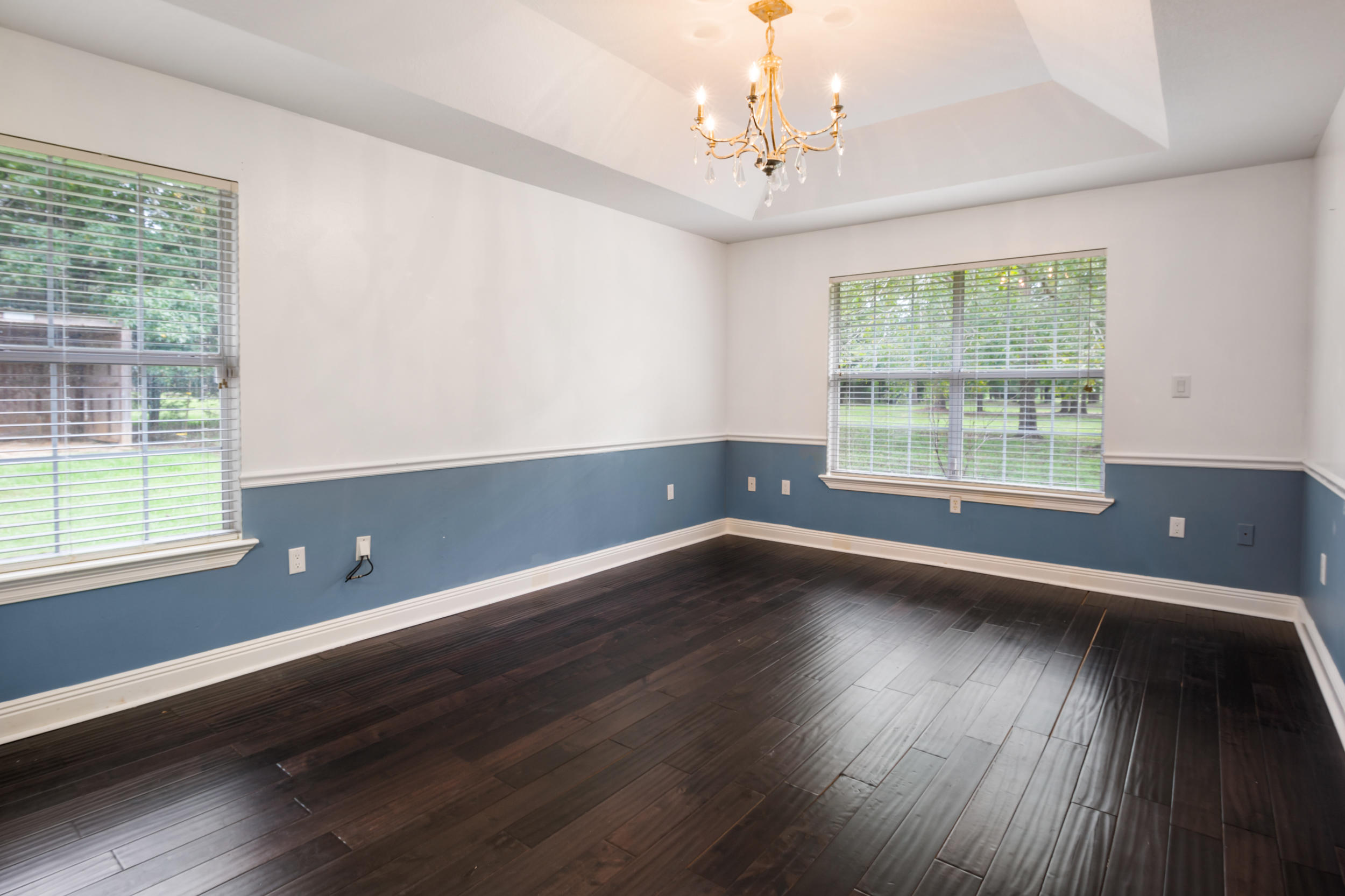 5975 Jack Stokes Road Baker, FL 32531 - Photo 22 of 44 a view of an empty room with wooden floor and a window