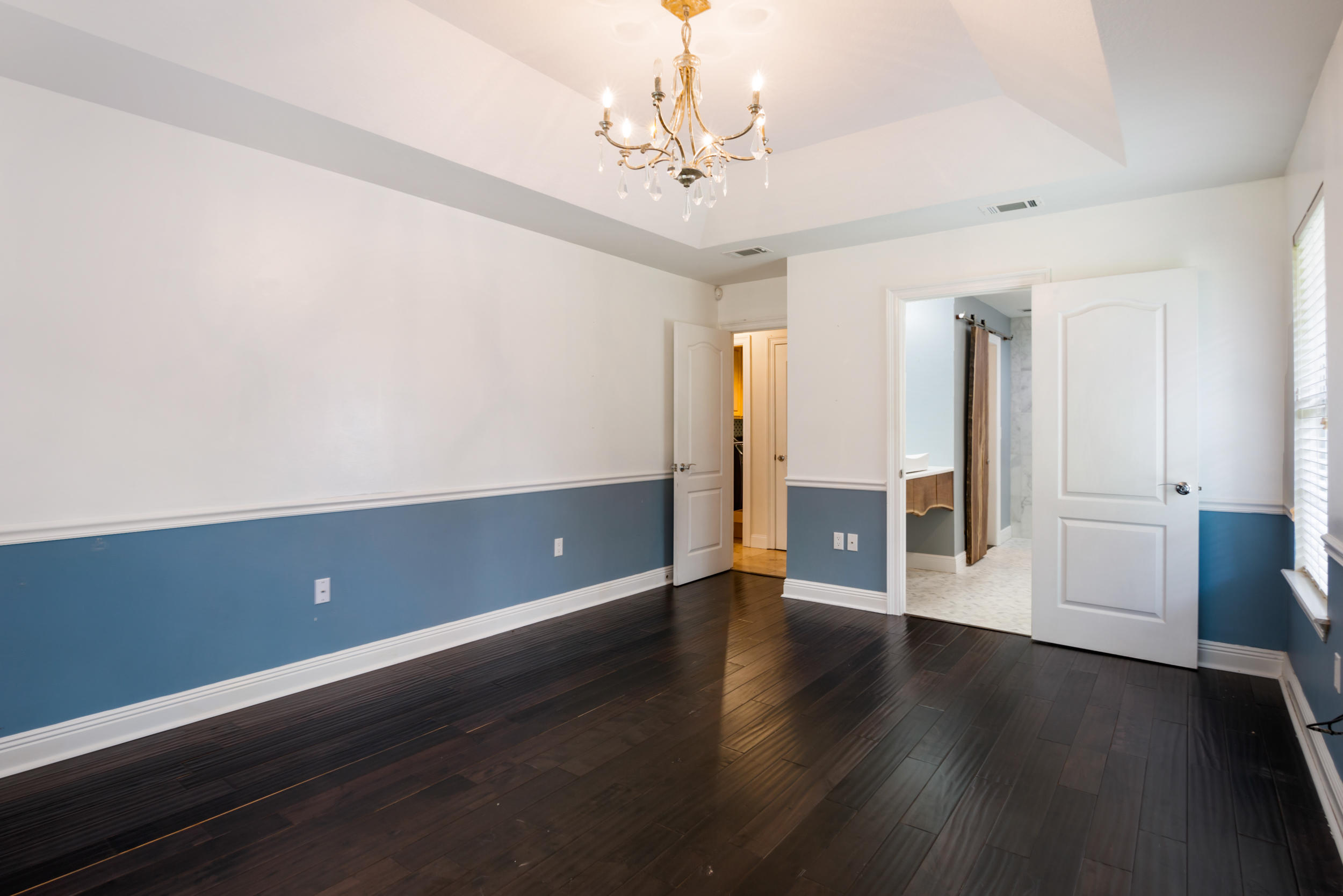 5975 Jack Stokes Road Baker, FL 32531 - Photo 23 of 44 a view of an empty room with wooden floor