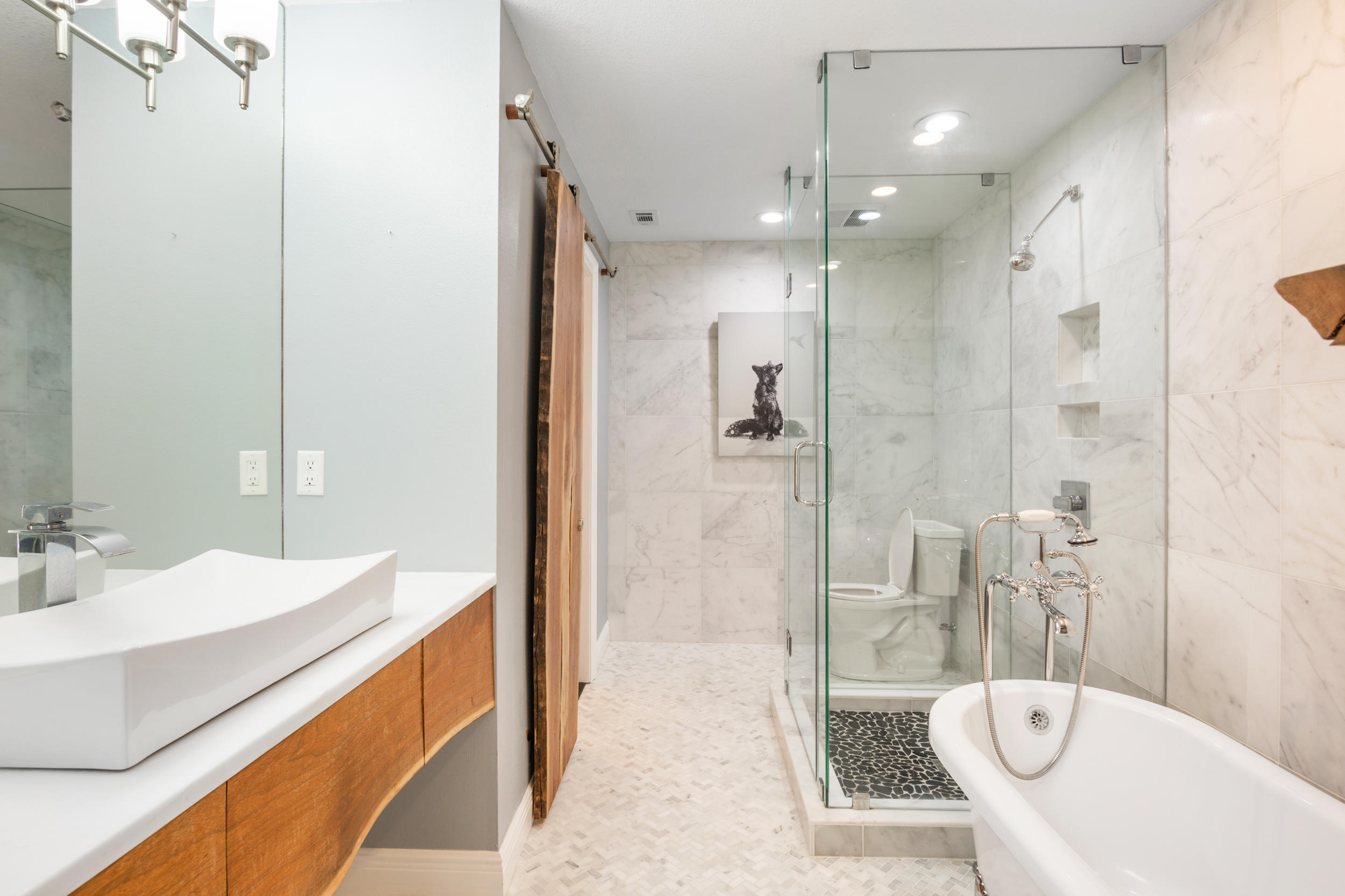 5975 Jack Stokes Road Baker, FL 32531 - Photo 25 of 44 a spacious bathroom with a bathtub shower sink mirror and toilet