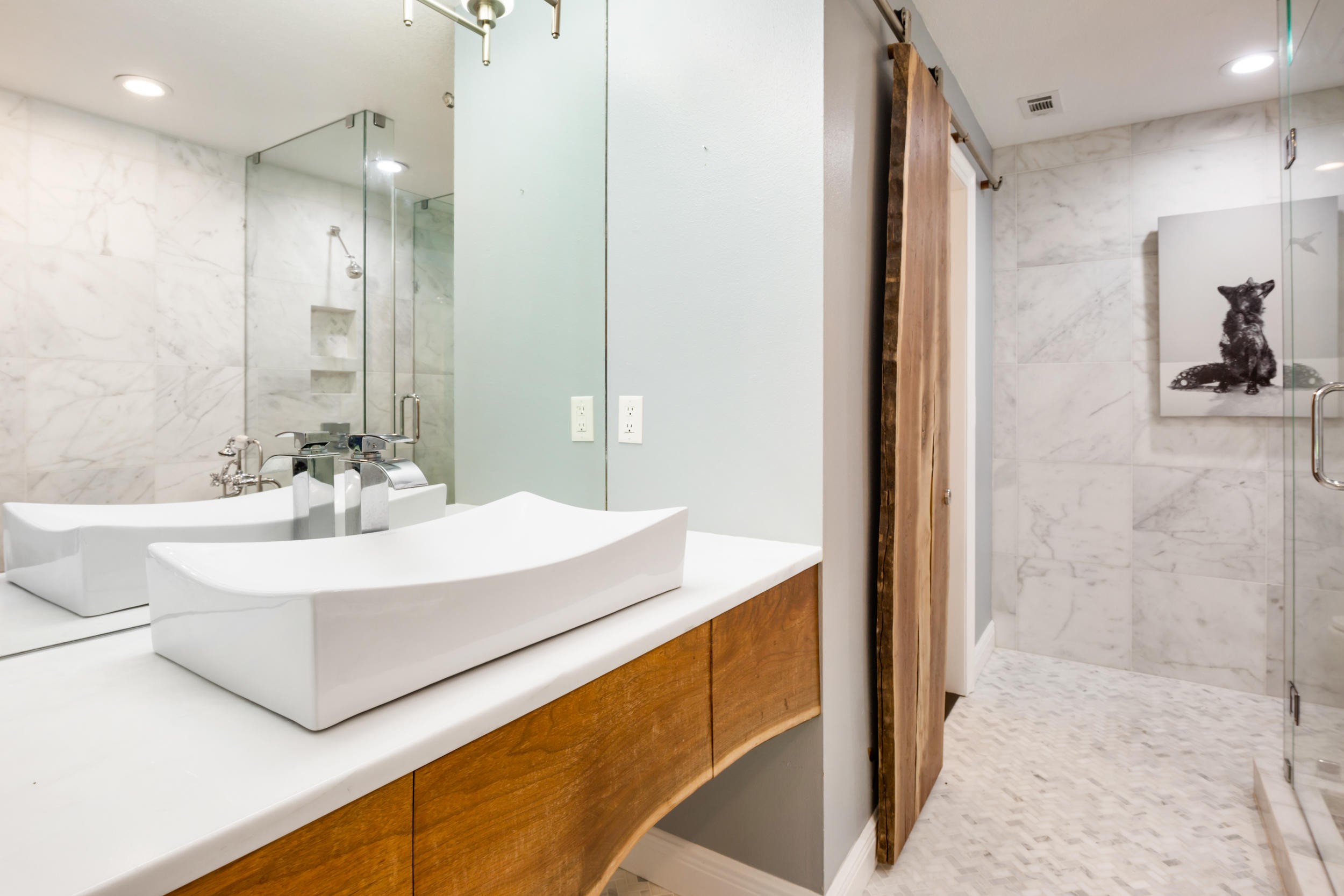 5975 Jack Stokes Road Baker, FL 32531 - Photo 26 of 44 a bathroom with a sink a mirror and a shower