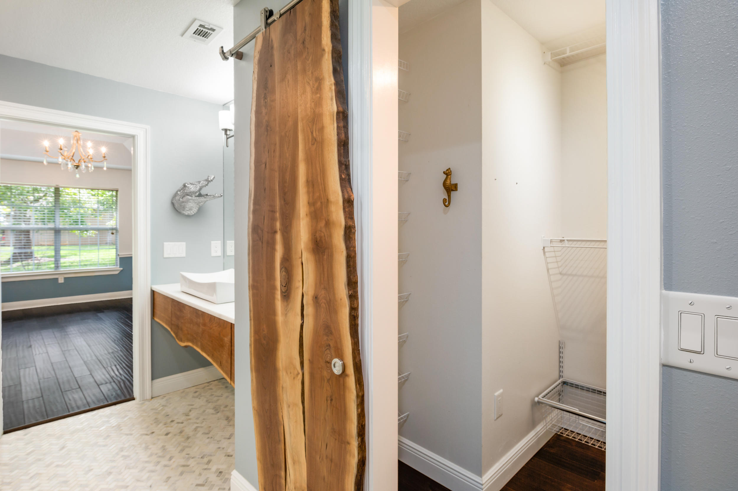 5975 Jack Stokes Road Baker, FL 32531 - Photo 29 of 44 a view of a hallway with wooden floor and glass door