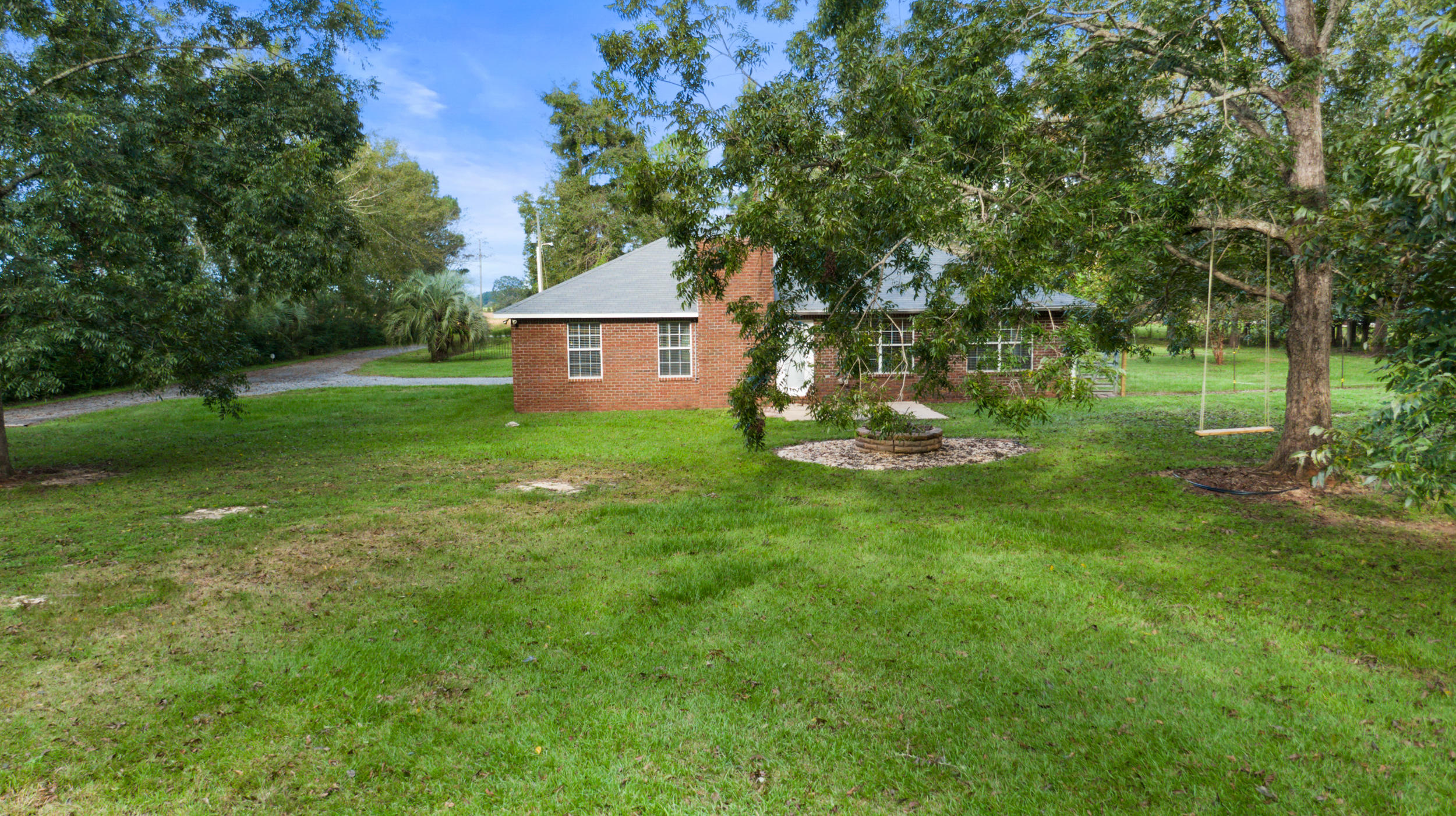 5975 Jack Stokes Road Baker, FL 32531 - Photo 30 of 44 a front view of a house with garden