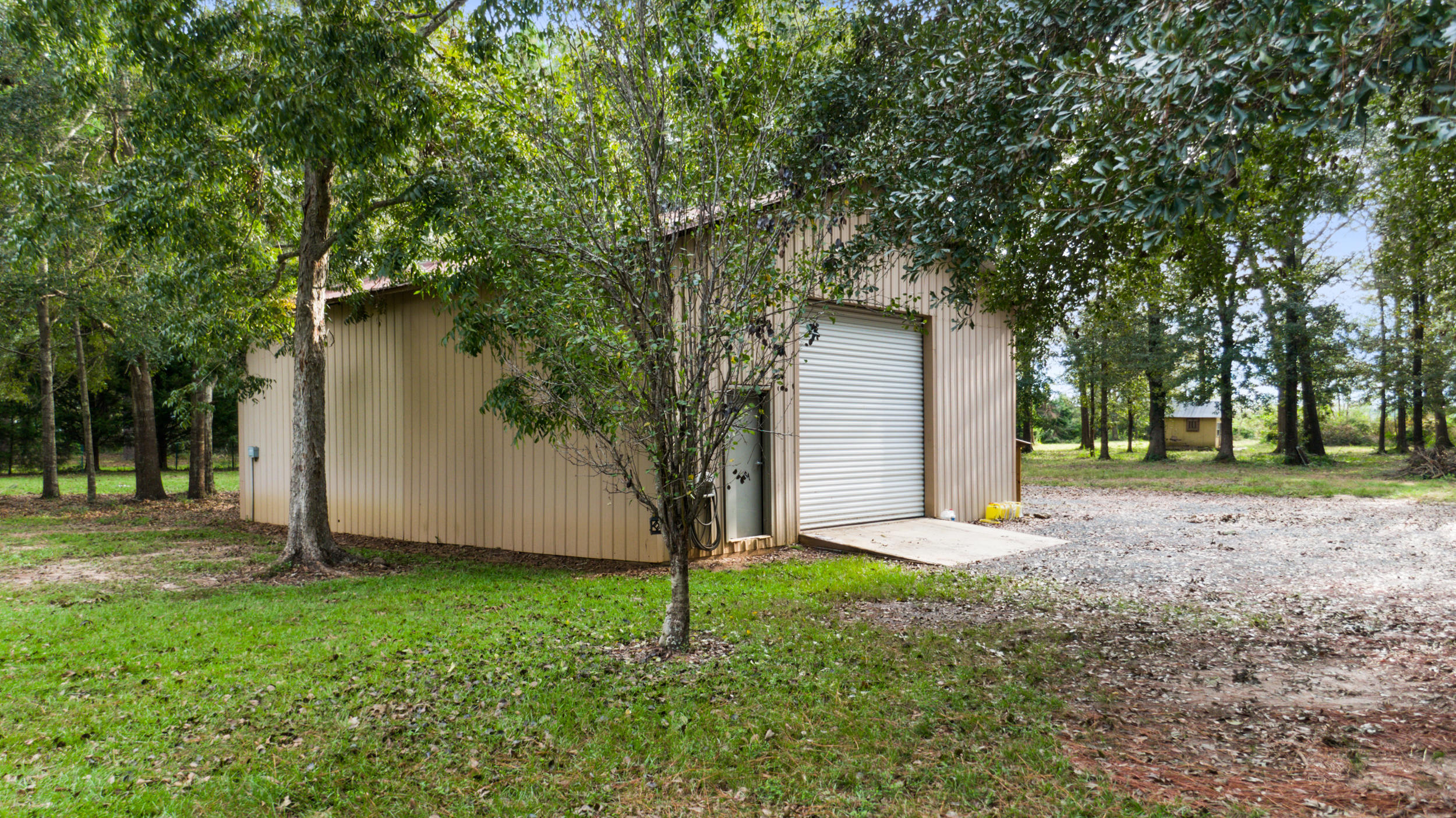 5975 Jack Stokes Road Baker, FL 32531 - Photo 36 of 44 a view of a house with backyard and tree