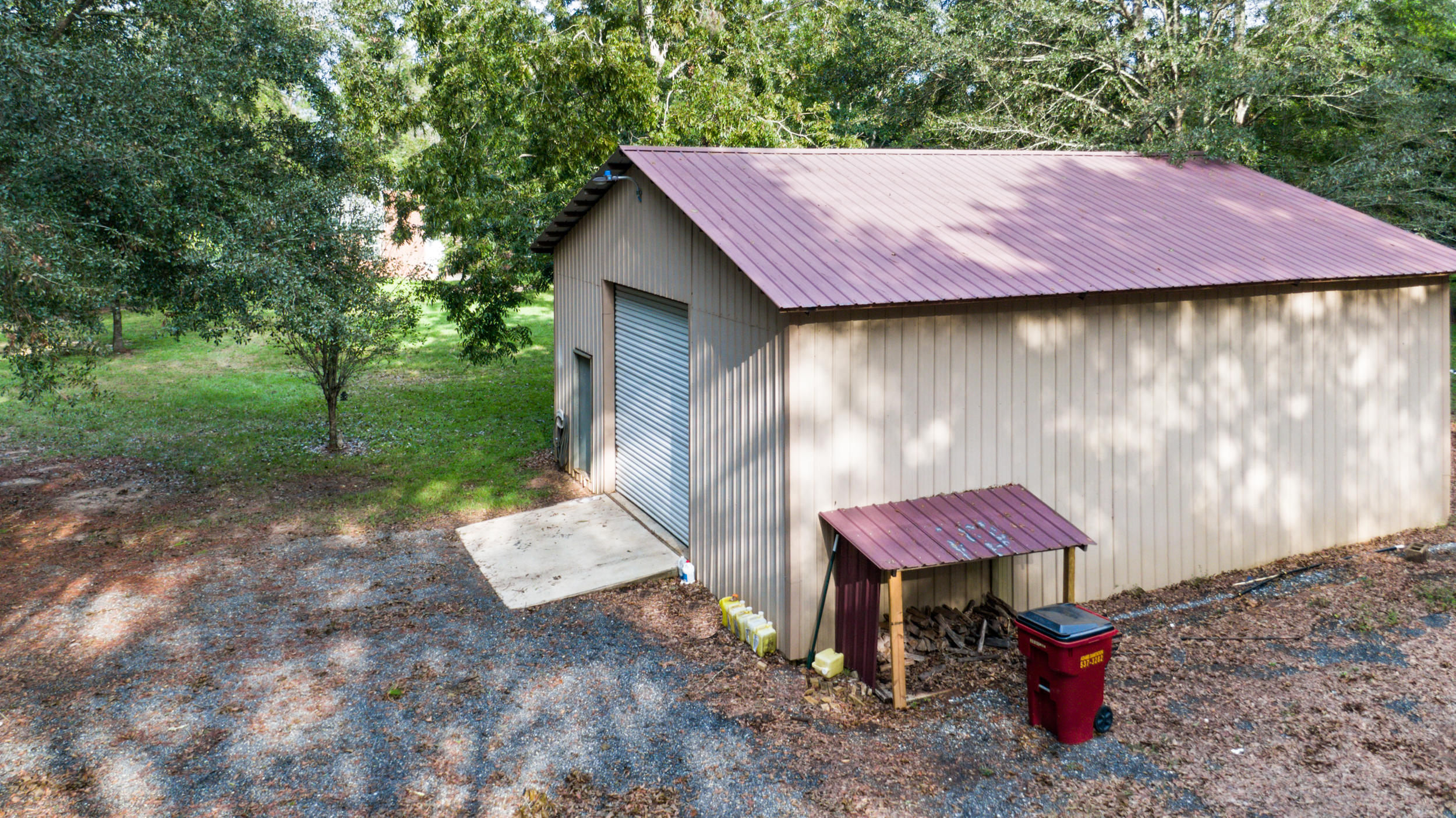 5975 Jack Stokes Road Baker, FL 32531 - Photo 39 of 44 a backyard of a house with table and chairs